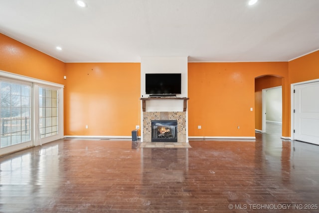 unfurnished living room featuring wood-type flooring and a fireplace