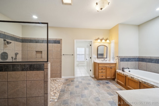 bathroom featuring independent shower and bath and vanity