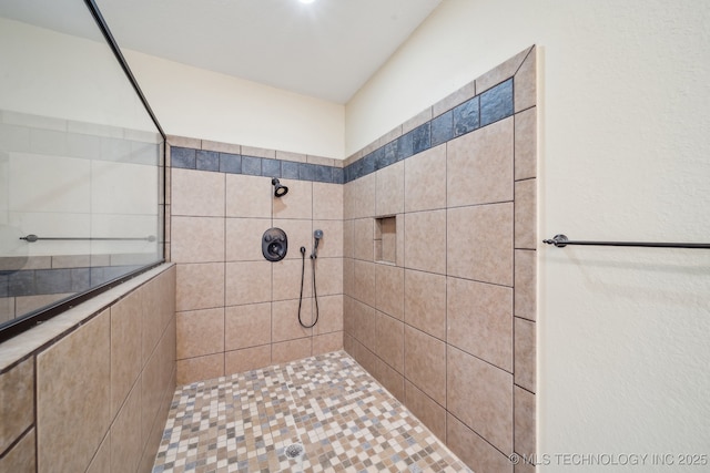 bathroom with tiled shower