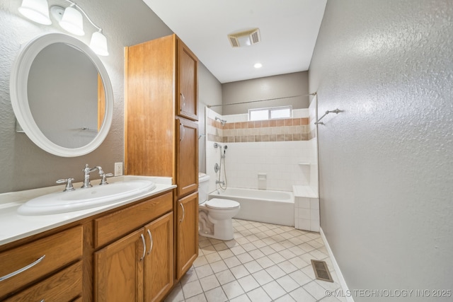 full bathroom with tile patterned flooring, vanity, tiled shower / bath combo, and toilet