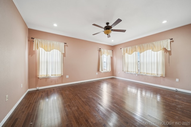 empty room featuring crown molding, dark wood-type flooring, and ceiling fan