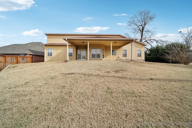 back of property with a lawn