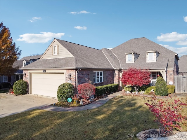 view of front of house with a garage and a front lawn