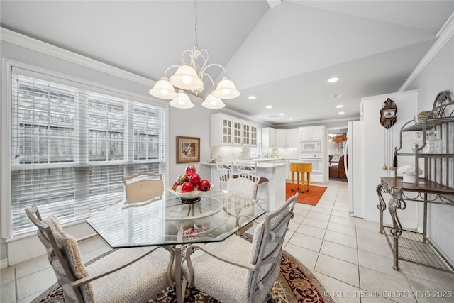 tiled dining space featuring ornamental molding, a chandelier, and high vaulted ceiling