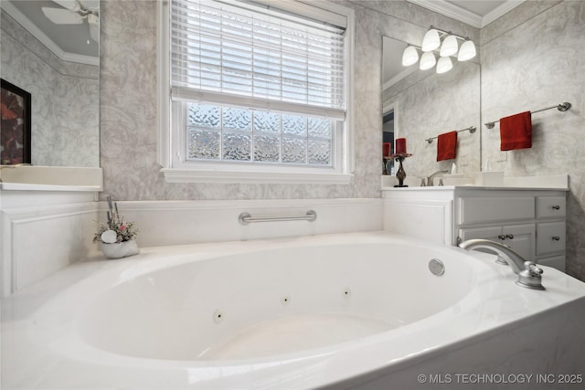 bathroom with crown molding, vanity, ceiling fan, and a tub to relax in