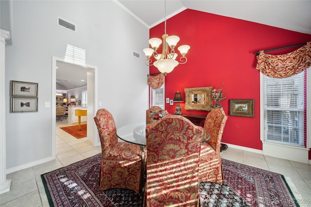 dining space featuring light tile patterned floors, high vaulted ceiling, and a chandelier