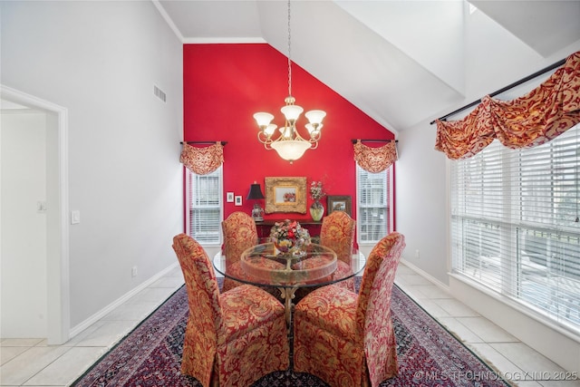 tiled dining area featuring a notable chandelier and high vaulted ceiling