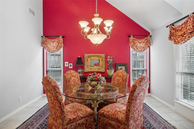 tiled dining area with an inviting chandelier and vaulted ceiling