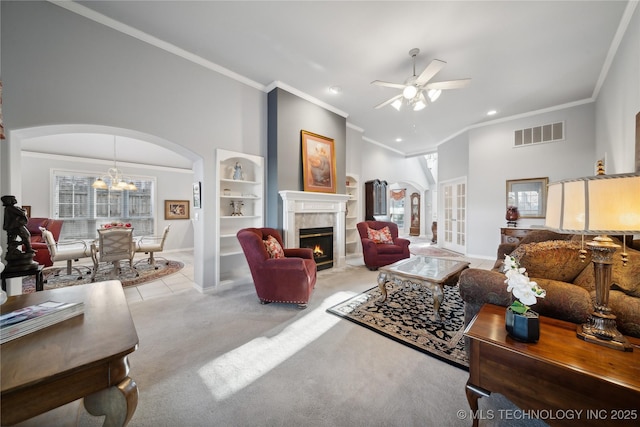 living room with crown molding, light colored carpet, and ceiling fan with notable chandelier