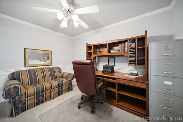 carpeted office space with ceiling fan and ornamental molding