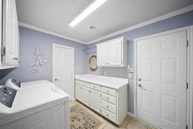 clothes washing area with independent washer and dryer, cabinets, crown molding, and sink