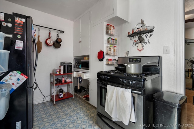 kitchen with white cabinetry, refrigerator, and range with gas cooktop