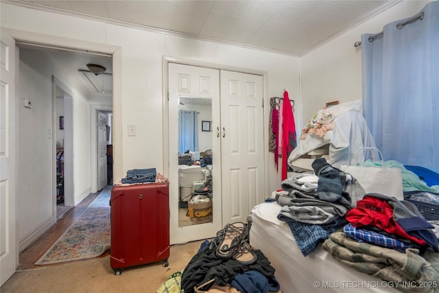 bedroom featuring crown molding and a closet