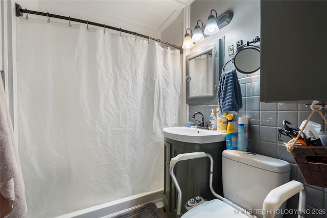 bathroom featuring tasteful backsplash, sink, toilet, and walk in shower