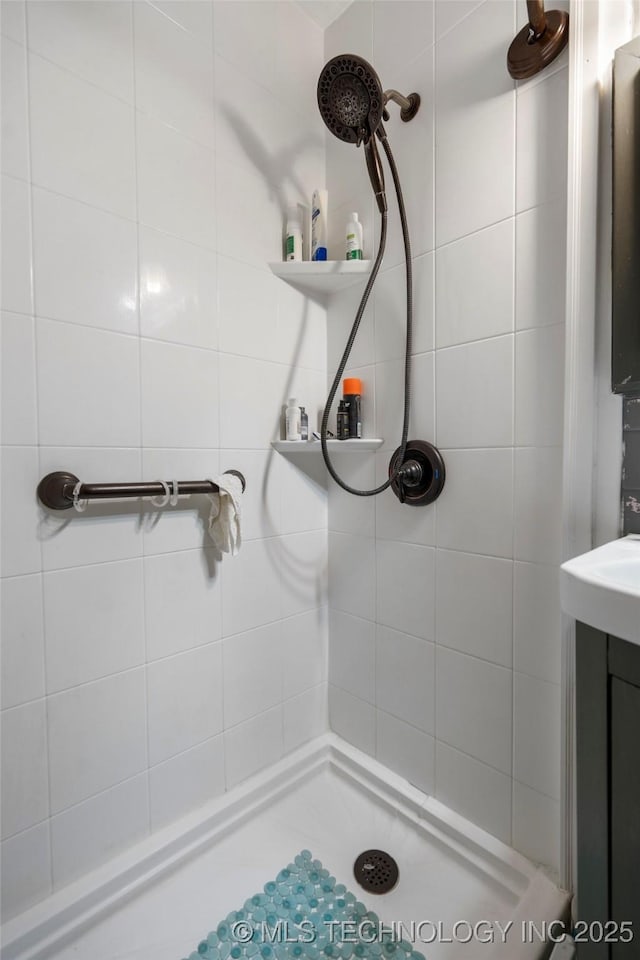 bathroom with tiled shower