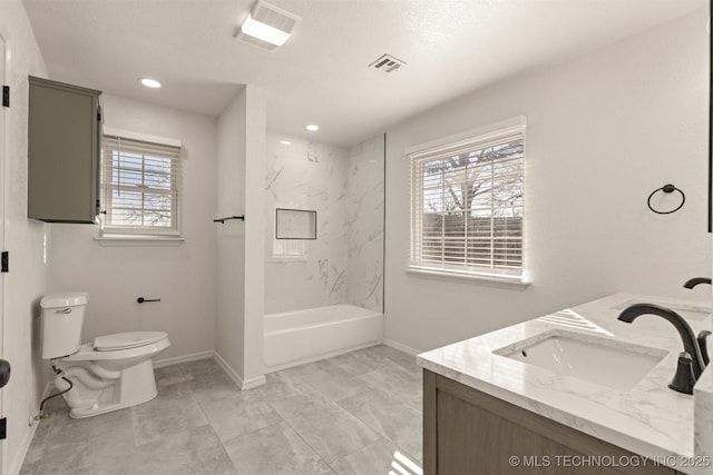 full bathroom with vanity, tiled shower / bath combo, plenty of natural light, and toilet