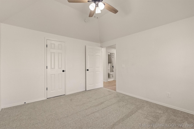 unfurnished bedroom with a closet, ceiling fan, vaulted ceiling, and light carpet