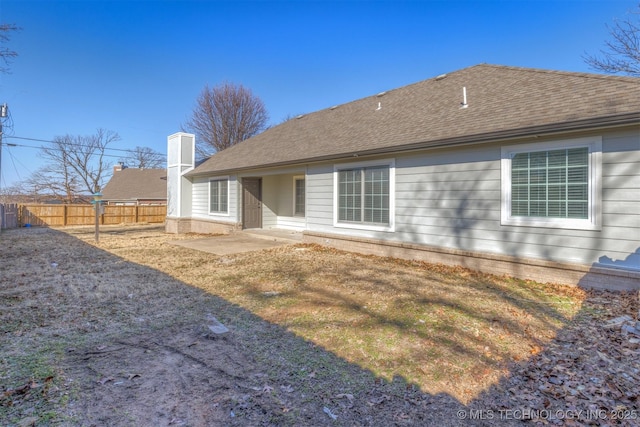 rear view of property with a patio area and a lawn