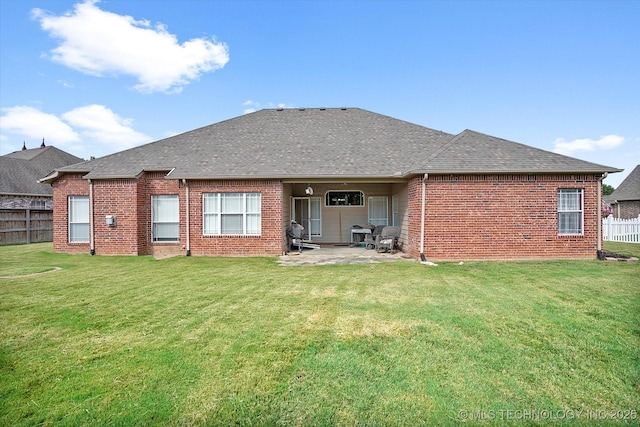 back of property featuring a lawn and a patio area