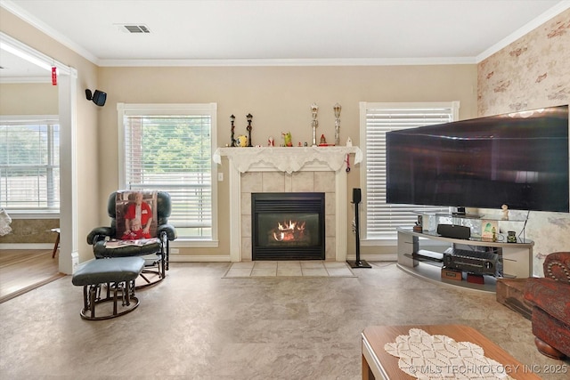 living room featuring crown molding and a fireplace