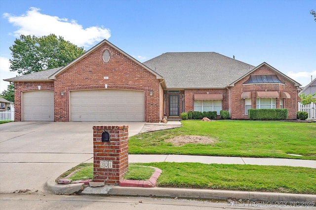 view of front of property featuring a garage and a front lawn