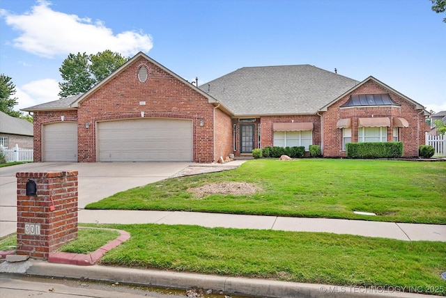 view of front of house featuring a garage and a front lawn