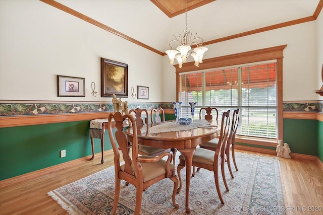 dining space featuring an inviting chandelier, crown molding, and light wood-type flooring