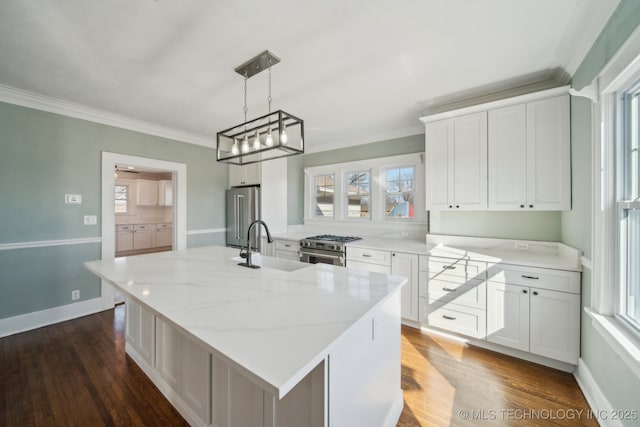 kitchen featuring white cabinetry, a center island, premium appliances, and decorative light fixtures