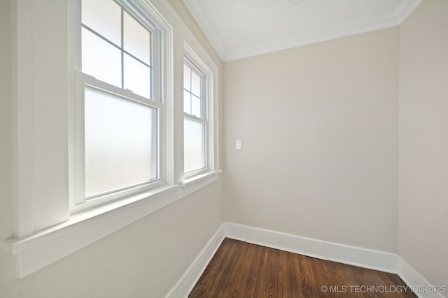 unfurnished room with crown molding, a healthy amount of sunlight, and dark hardwood / wood-style flooring