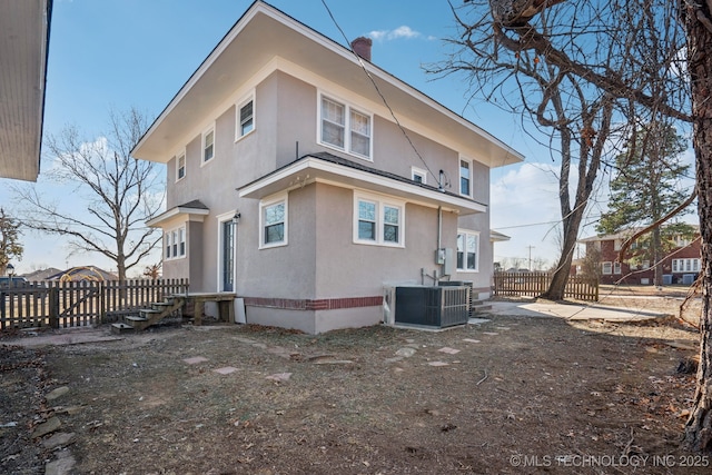 back of property with central AC