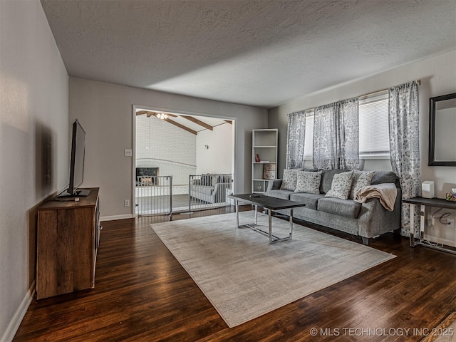 living room featuring dark hardwood / wood-style floors and a textured ceiling