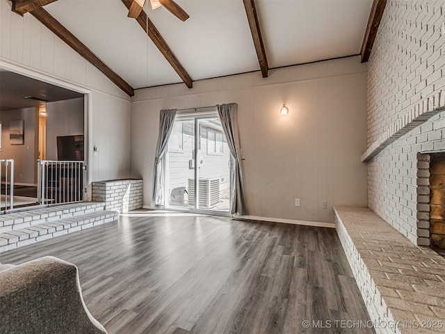 unfurnished living room featuring vaulted ceiling with beams, hardwood / wood-style flooring, and ceiling fan