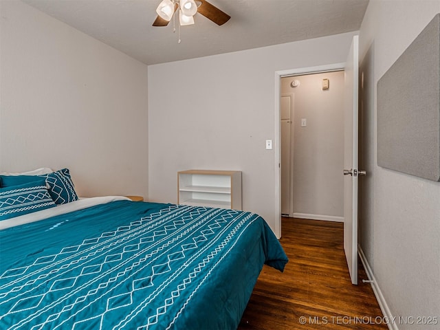 bedroom with dark hardwood / wood-style flooring and ceiling fan