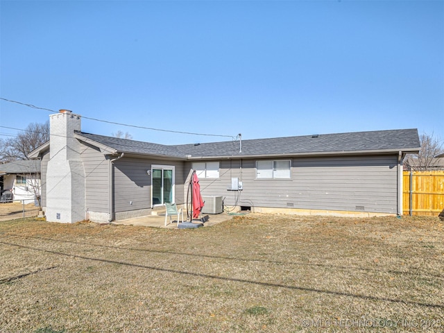 back of property featuring a lawn, central AC unit, and a patio area