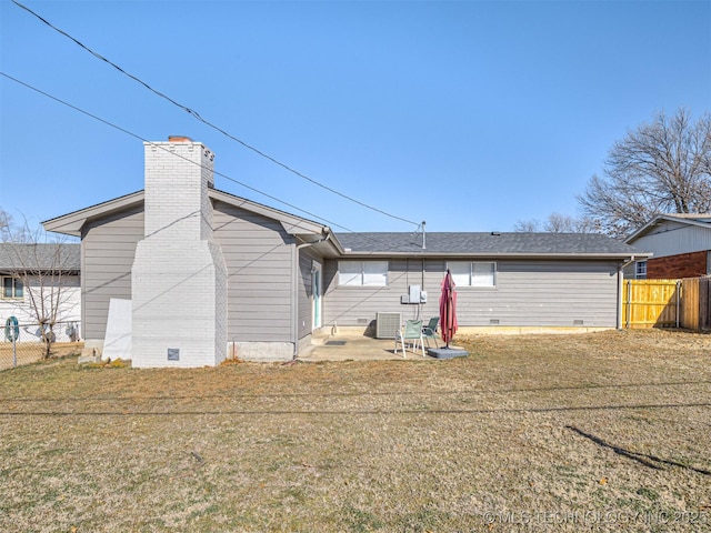 rear view of property with a patio area and a lawn