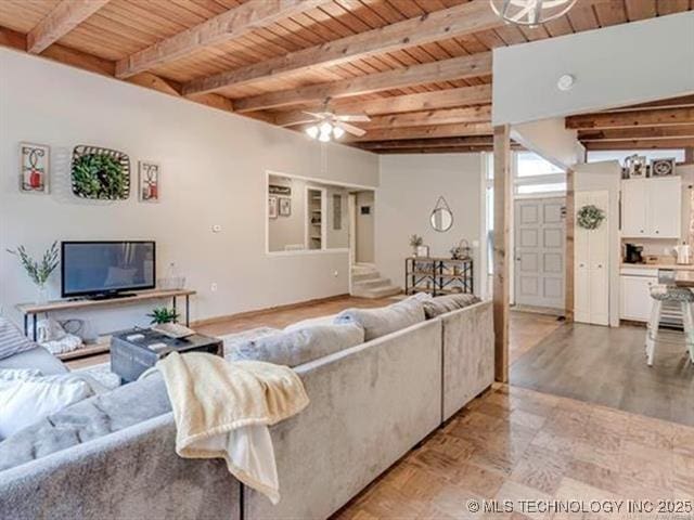 living room with wood ceiling, ceiling fan, and beam ceiling