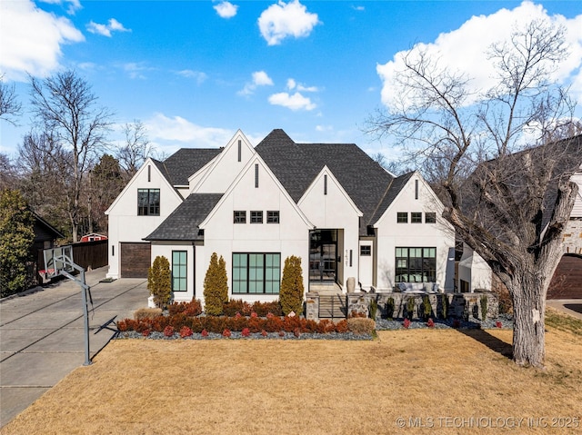 view of front of home featuring a garage and a front lawn