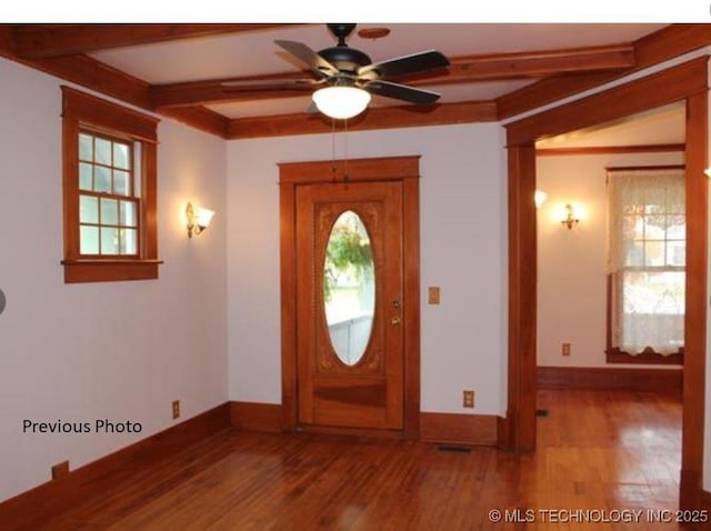 entrance foyer with hardwood / wood-style flooring, ceiling fan, a wealth of natural light, and beam ceiling