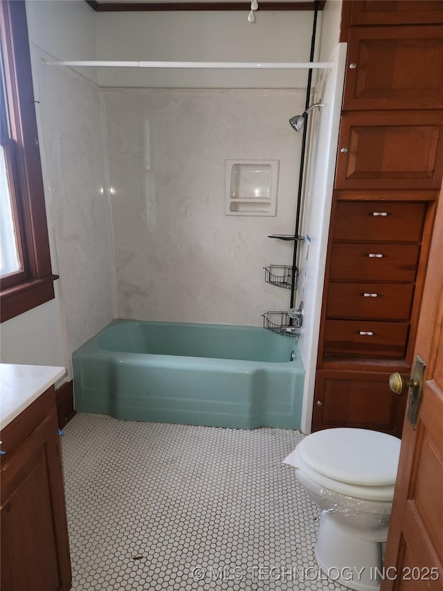 full bathroom featuring vanity, tub / shower combination, and toilet