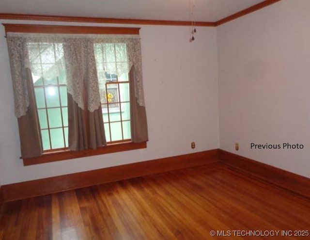 unfurnished room with ornamental molding and hardwood / wood-style floors