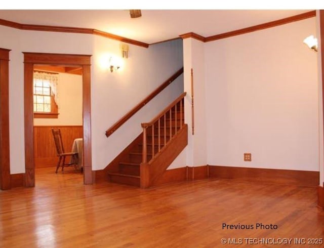 empty room with crown molding and hardwood / wood-style floors