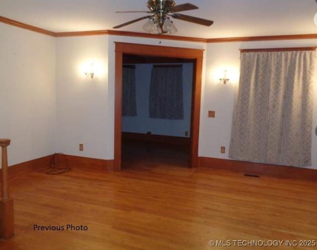 empty room featuring hardwood / wood-style floors, ornamental molding, and ceiling fan