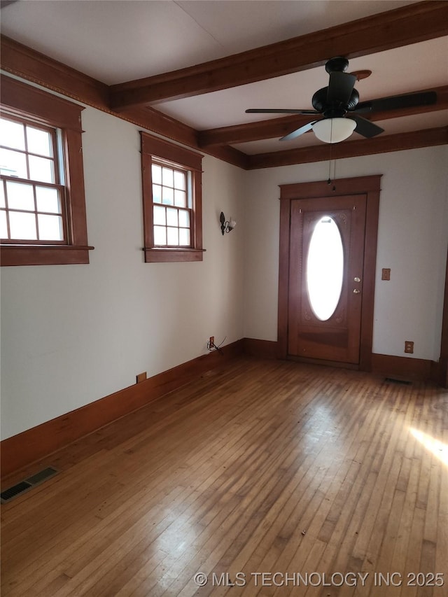 entryway featuring beam ceiling, wood-type flooring, and ceiling fan