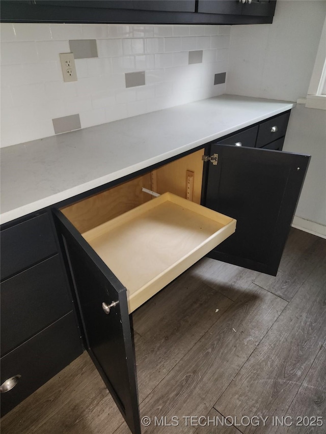 kitchen featuring dark hardwood / wood-style flooring and backsplash