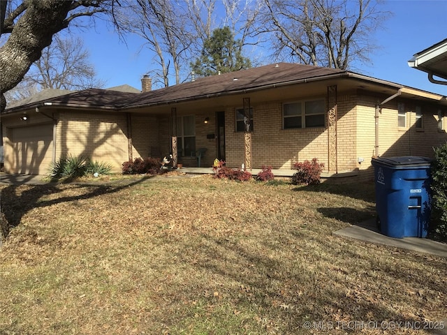 single story home featuring a garage and a front yard