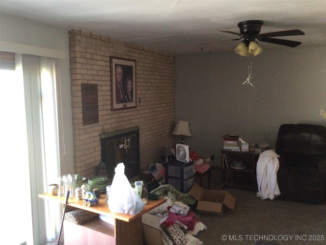 living room featuring ceiling fan and a brick fireplace