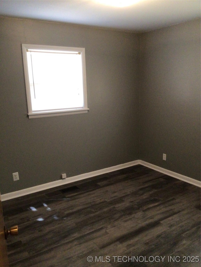 empty room with dark hardwood / wood-style floors