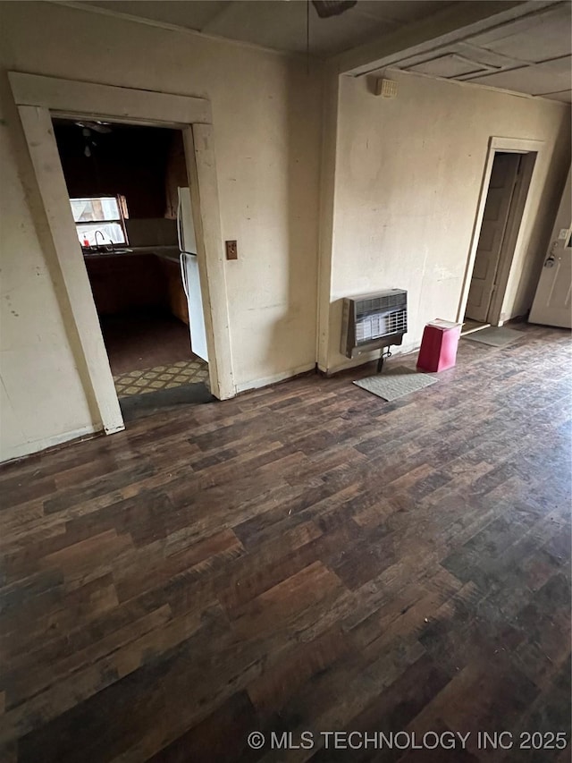 spare room featuring dark hardwood / wood-style floors and heating unit