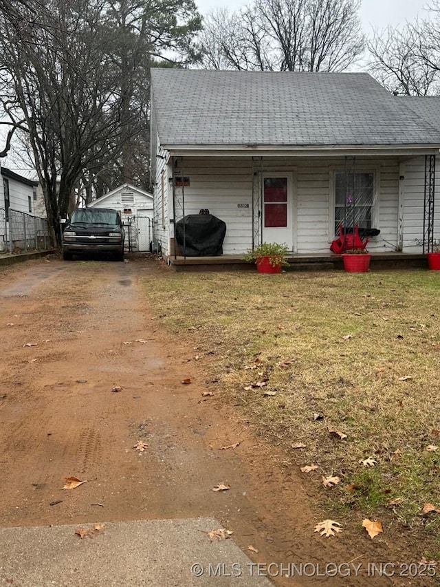 exterior space featuring covered porch and a lawn