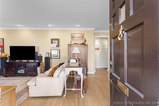 living room with ornamental molding and light hardwood / wood-style flooring